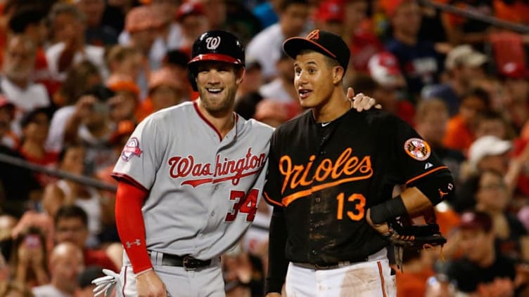 BALTIMORE, MD - JULY 10: Bryce Harper #34 of the Washington Nationals and Manny Machado #13 of the Baltimore Orioles talk during their game at Oriole Park at Camden Yards on July 10, 2015 in Baltimore, Maryland. (Photo by Rob Carr/Getty Images)