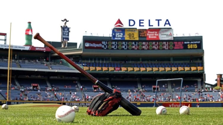 Jul 21, 2015; Atlanta, GA, USA; A baseball, baseball glove and baseballs are shown on the infield during batting practice before the game against the Atlanta Braves and the Los Angeles Dodgers at Turner Field. Mandatory Credit: Jason Getz-USA TODAY Sports