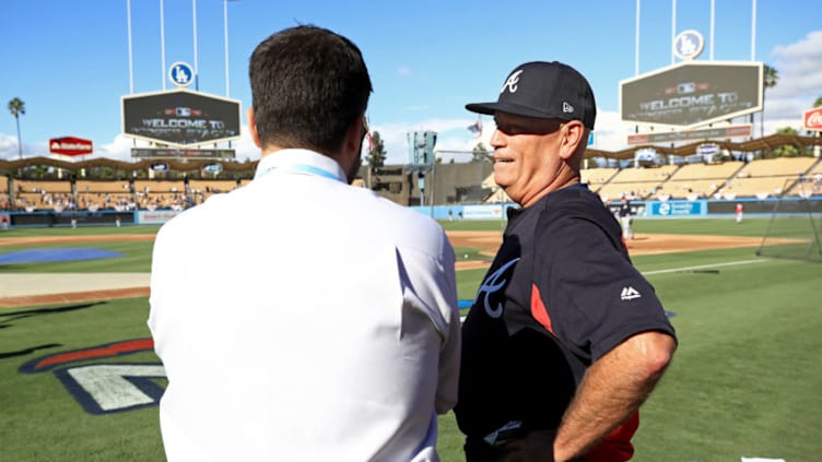 LOS ANGELES, CA - OCTOBER 04: General manager Alex Anthopoulos and manager Brian Snitker #43 of the Atlanta Braves talk during batting practice prior to Game One of the National League Division Series against the Los Angeles Dodgers at Dodger Stadium on October 4, 2018 in Los Angeles, California. (Photo by Sean M. Haffey/Getty Images)