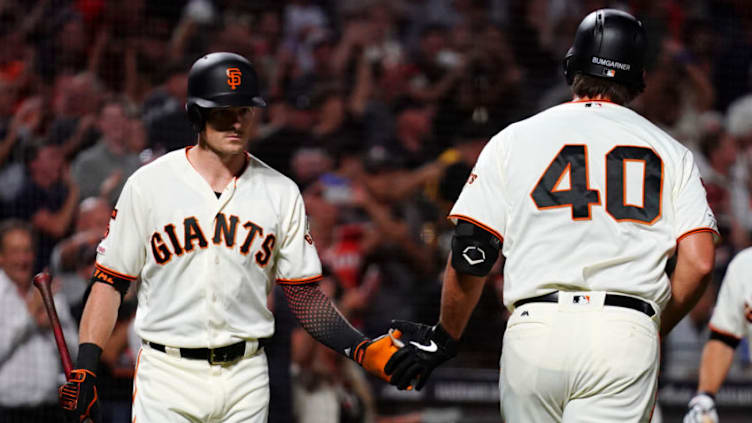 SAN FRANCISCO, CALIFORNIA - SEPTEMBER 24: Madison Bumgarner #40 celebrates a solo home run with Mike Yastrzemski #5 of the San Francisco Giants during the third inning against the Colorado Rockies at Oracle Park on September 24, 2019 in San Francisco, California. (Photo by Daniel Shirey/Getty Images)