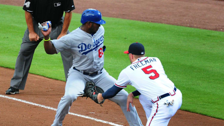 Atlanta Braves 1st baseman Freddie Freeman picks off his future teammate, Yasiel Puig. (Photo by Scott Cunningham/Getty Images)