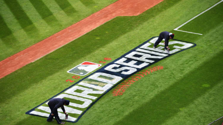 CLEVELAND, OH - OCTOBER 24: Members of the Cleveland Indians grounds crew paint the World Series logo on the field prior to Media Day at Progressive Field on October 24, 2016 in Cleveland, Ohio. (Photo by Jason Miller/Getty Images)