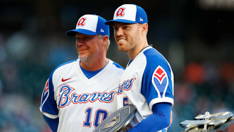 Freddie Freeman of the Atlanta Braves accepts his 2020 MVP trophy from former Brave Chipper Jones on April 11, 2021, Georgia. (Photo by Todd Kirkland/Getty Images)