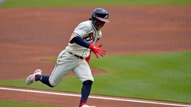 ATLANTA, GA - OCTOBER 03: Ozzie Albies #1 of the Atlanta Braves runs to home plate in the first inning against the New York Mets at Truist Park on October 3, 2021 in Atlanta, Georgia. (Photo by Edward M. Pio Roda/Getty Images)