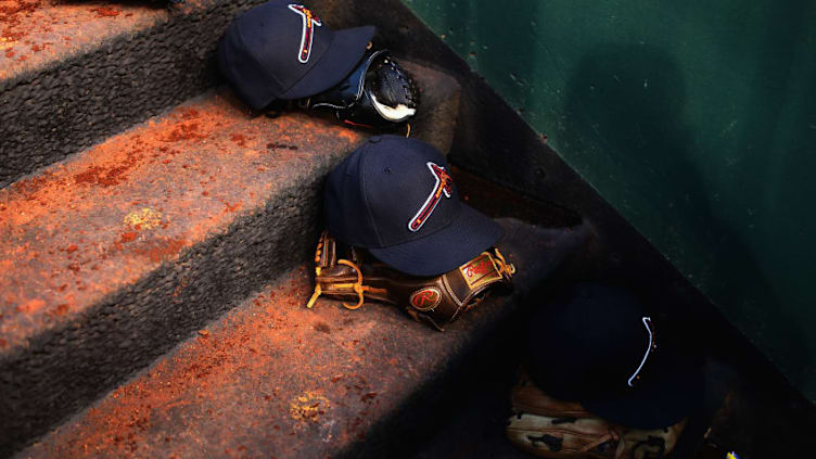 WASHINGTON, DC - SEPTEMBER 13: Gloves and hats of the Atlanta Braves sit on the steps of the dugout against the Washington Nationals at Nationals Park on September 13, 2017 in Washington, DC. (Photo by Rob Carr/Getty Images)