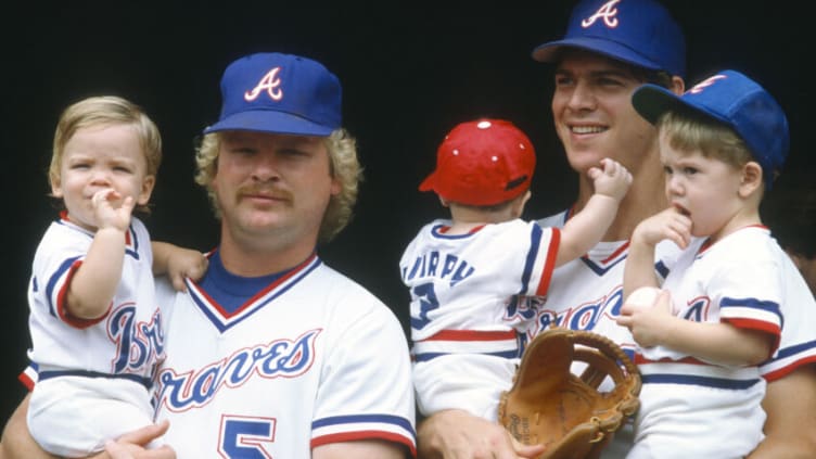 ATLANTA, GA - CIRCA 1982: Bob Horner #5 and Dale Murphy #3 of the Atlanta Braves holds their kids in their arms prior to the start of Major League Baseball game circa 1982 at Atlanta-Fulton County Stadium in Atlanta, Georgia. Horner played for the Braves from 1978-86. (Photo by Focus on Sport/Getty Images)