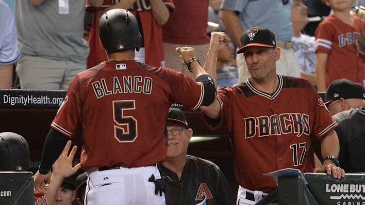 Torey Lovullo, greeting Gregor Blanco (5), has created a positive clubhouse environment. (Jennifer Stewart / Getty Images)