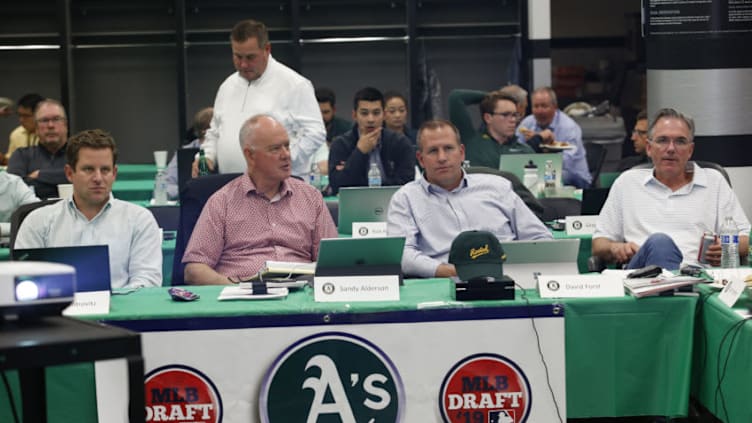 Assistant General Manager Dan Kantrovitz, Adviser Sandy Alderson, General Manager David Forst and Executive Vice President of Baseball Operations Billy Beane of the Oakland Athletics sit in the Athletics draft room, during the opening day of the 2019 MLB draft, at the Oakland-Alameda County Coliseum on June 3, 2019 in Oakland, California. (Photo by Michael Zagaris/Oakland Athletics/Getty Images)