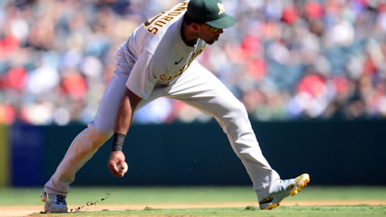 Sep 19, 2021; Anaheim, California, USA; Oakland Athletics shortstop Elvis Andrus (17) fields a hit by Los Angeles Angels third baseman Jack Mayfield (9) and throws to first for the out during the fifth inning at Angel Stadium. Mandatory Credit: Gary A. Vasquez-USA TODAY Sports