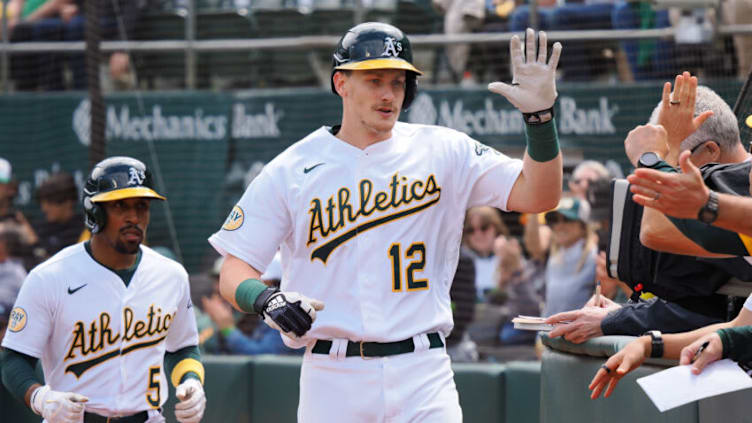 Apr 21, 2022; Oakland, California, USA; Oakland Athletics catcher Sean Murphy (12) high fives teammates after hitting a two-run home run against the Baltimore Orioles during the fifth inning at RingCentral Coliseum. Mandatory Credit: Kelley L Cox-USA TODAY Sports