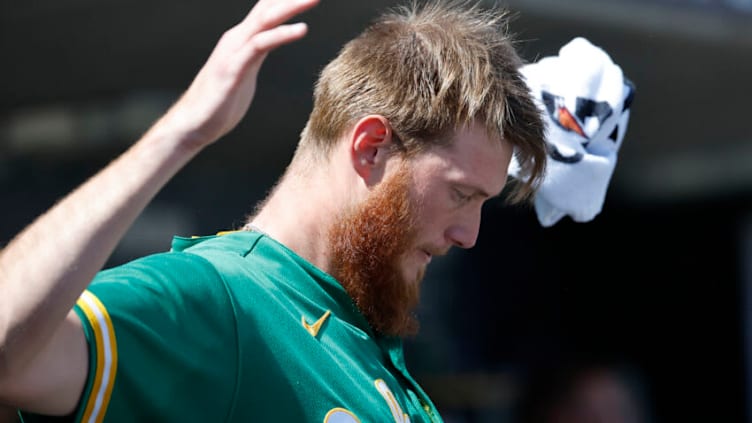 May 12, 2022; Detroit, Michigan, USA; Oakland Athletics relief pitcher A.J. Puk (33) stretches in the dugout during the eighth inning against the Detroit Tigers at Comerica Park. Mandatory Credit: Rick Osentoski-USA TODAY Sports