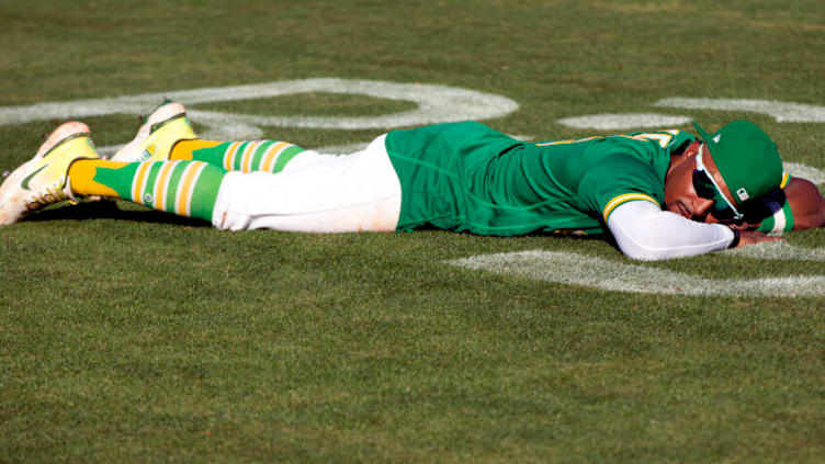 Oct 5, 2022; Oakland, California, USA; Oakland Athletics left fielder Tony Kemp (5) lays on the field following his team’s final game of the season, a 3-2 victory over the Los Angeles Angels at RingCentral Coliseum. Mandatory Credit: D. Ross Cameron-USA TODAY Sports