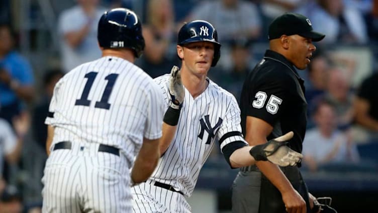 NEW YORK, NEW YORK - MAY 31: Home plate umpire Jeremie Rehak looks on as DJ LeMahieu #26 and Brett Gardner #11 of the New York Yankees celebrate after both scored during the third inning against the Boston Red Sox at Yankee Stadium on May 31, 2019 in New York City. (Photo by Jim McIsaac/Getty Images)