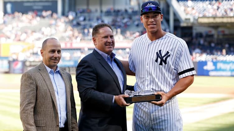 NEW YORK, NY - OCTOBER 1: Brian Cashman general manager of the New York Yankees, left, and Damon Oppenheimer amateur scouting director of the New York Yankees, center, present Aaron Judge of the New York Yankees with a crystal gavel before the Yankees final regular season baseball game against the Toronto Blue Jays at Yankee Stadium on October 1, 2017 in the Bronx borough of New York City. (Photo by Adam Hunger/Getty Images)