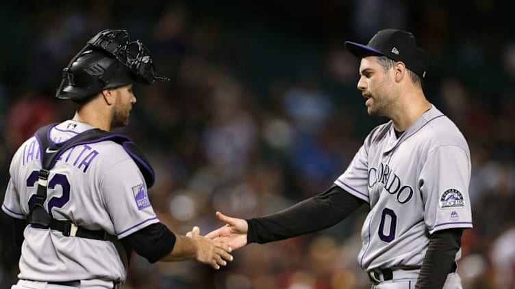 PHOENIX, AZ - JULY 20: Pitcher Adam Ottavino #0 of the Colorado Rockies is congratulated by teammate Chris Iannetta #22 after a 11-10 victory against the Arizona Diamondbacks during an MLB game at Chase Field on July 20, 2018 in Phoenix, Arizona. (Photo by Ralph Freso/Getty Images)