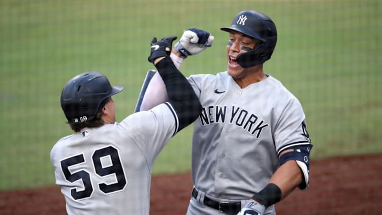 SAN DIEGO, CALIFORNIA - OCTOBER 09: Aaron Judge #99 of the New York Yankees is congratulated by Luke Voit #59 after hitting a solo home run against the Tampa Bay Rays during the fourth inning in Game Five of the American League Division Series at PETCO Park on October 09, 2020 in San Diego, California. (Photo by Christian Petersen/Getty Images)