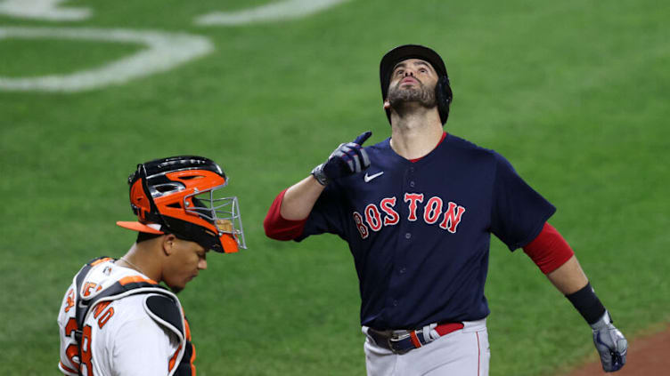 BALTIMORE, MARYLAND - SEPTEMBER 29: J.D. Martinez #28 of the Boston Red Sox celebrates in front of catcher Pedro Severino #28 of the Baltimore Orioles after hitting a second-inning solo home run at Oriole Park at Camden Yards on September 29, 2021 in Baltimore, Maryland. (Photo by Rob Carr/Getty Images)