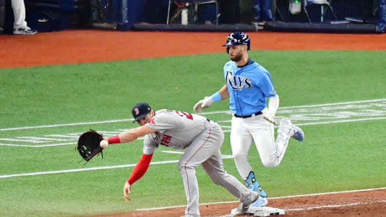 ST. PETERSBURG, FLORIDA - AUGUST 01: Kevin Kiermaier #39 of the Tampa Bay Rays reaches first base ahead of the throw to Bobby Dalbec #29 of the Boston Red Sox in the seventh inning at Tropicana Field on August 01, 2021 in St. Petersburg, Florida. (Photo by Julio Aguilar/Getty Images)