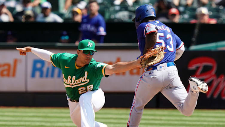 OAKLAND, CALIFORNIA - AUGUST 08: Matt Olson #28 of the Oakland Athletics forces Adolis Garcia #53 of the Texas Rangers out at first during the sixth inning at RingCentral Coliseum on August 08, 2021 in Oakland, California. (Photo by Ben Green/Getty Images)