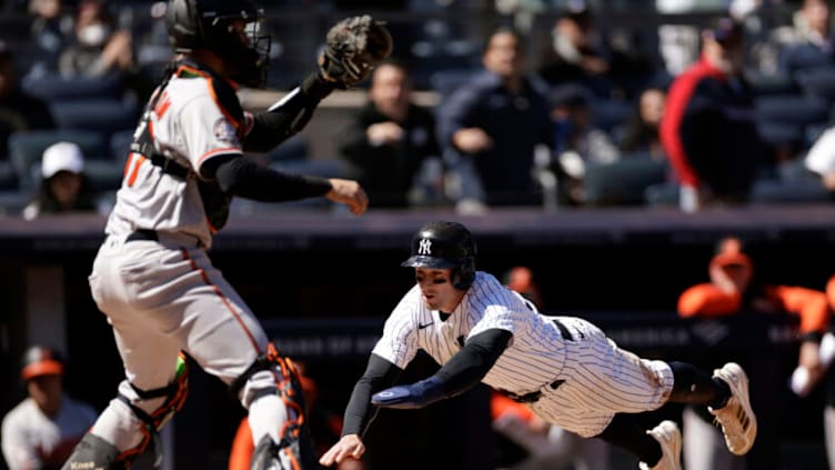 NEW YORK, NY - APRIL 28: Tim Locastro #33 of the New York Yankees scores a run past Anthony Bemboom #37 of the Baltimore Orioles during the fifth inning at Yankee Stadium on April 28, 2022 in New York City. (Photo by Adam Hunger/Getty Images)