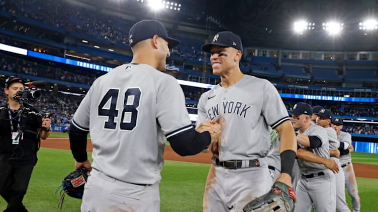 TORONTO, ON - SEPTEMBER 27: Aaron Judge #99 of the New York Yankees high-fives Anthony Rizzo #48 after defeating the Toronto Blue Jays to clinch first place in the American League East after the game at Rogers Centre on on September 27, 2022, in Toronto, Canada. (Photo by New York Yankees/Getty Images)