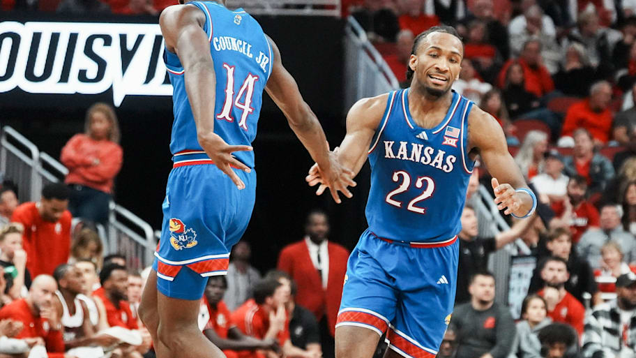 Kansas guard Darryn Peterson slaps hands with a teammate during a game.