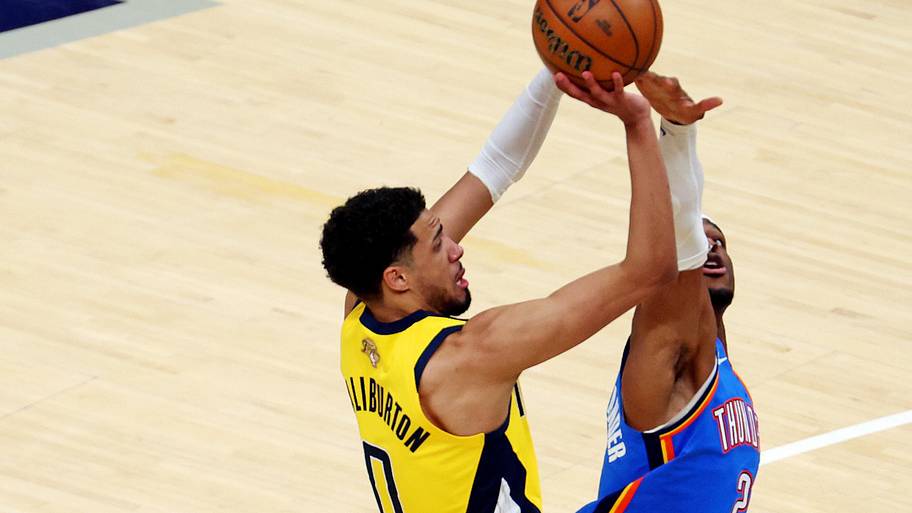 Indiana Pacers guard Tyrese Haliburton shoots the ball against Oklahoma City Thunder guard Shai Gilgeous-Alexander.