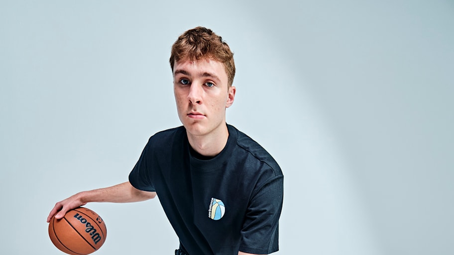 Cooper Flagg poses for a Sports Illustrated portrait with a basketball in his hands in a dribbling motion.