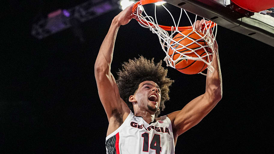 Asa Newell dunks during a college basketball game.