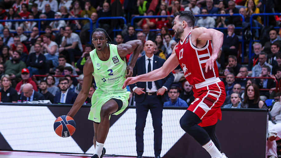 Dame Sarr of FC Barcelona competes for the ball against Giampaolo Ricci of EA7 Emporio Armani Milan in the EuroLeague.