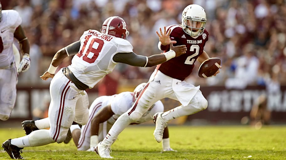 Texas A&M QB Johnny Manziel rushes against Alabama's Reggie Ragland in 2013.