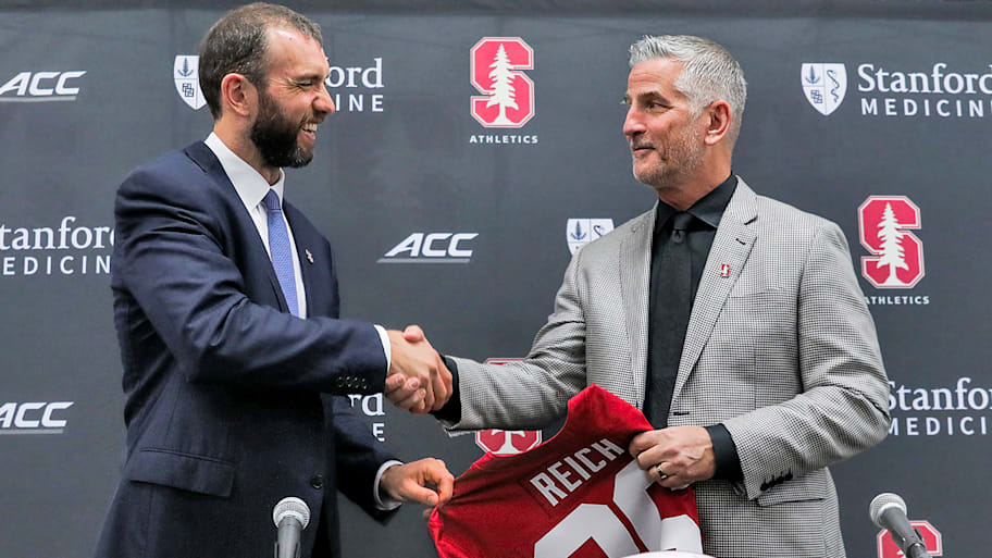 Andrew Luck shakes hands with Frank Reich during the press conference to announce Reich as interim football coach.