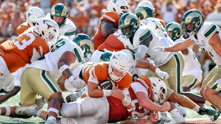 Arch Manning dives into the end zone for a touchdown.