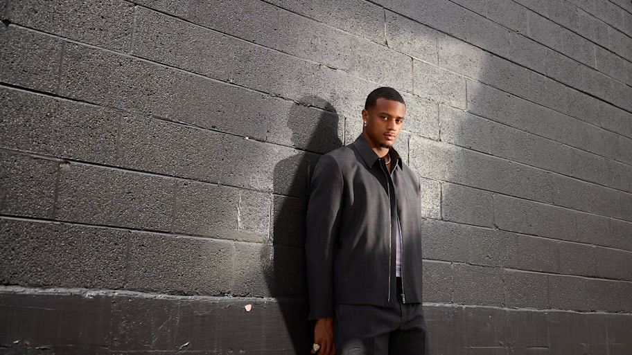 Pat Surtain II poses against a black wall