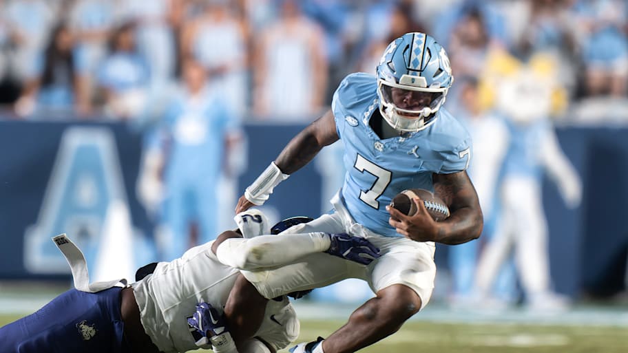 North Carolina quarterback Gio Lopez is tackled by TCU.