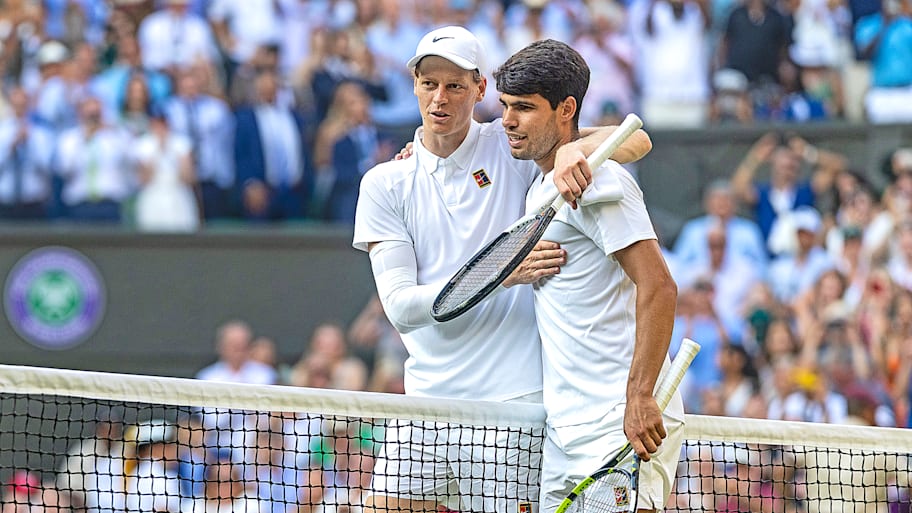 Jannik Sinner and Carlos Alcaraz embrace at the net after the Wimbledon Singles Final.