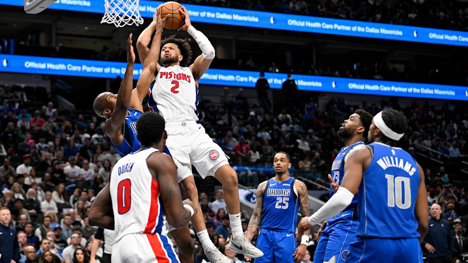 Detroit Pistons guard Cade Cunningham shoots the ball over Dallas Mavericks players.