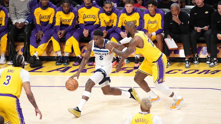 Minnesota Timberwolves shooting guard Anthony Edwards dribbles past Los Angeles Lakers guard/forward LeBron James.