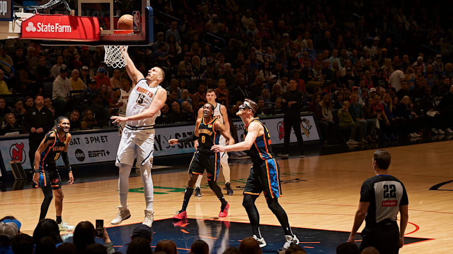 Denver Nuggets center Nikola Jokić drives to the basket.