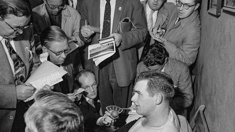 Yankee hurler Don Larsen is surrounded by newsmen after t pitched the first perfect game in the 1956 World Series