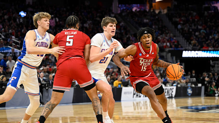 Texas Tech forward JT Toppin drives to the hoop past Florida forward Alex Condon.