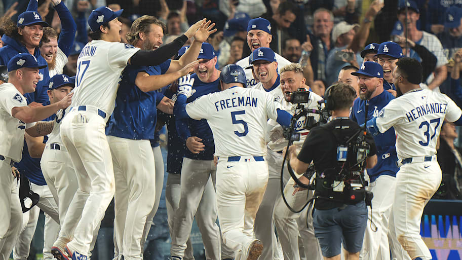 Dodgers players celebrate at the plate after Freddie Freeman's walk-off homer