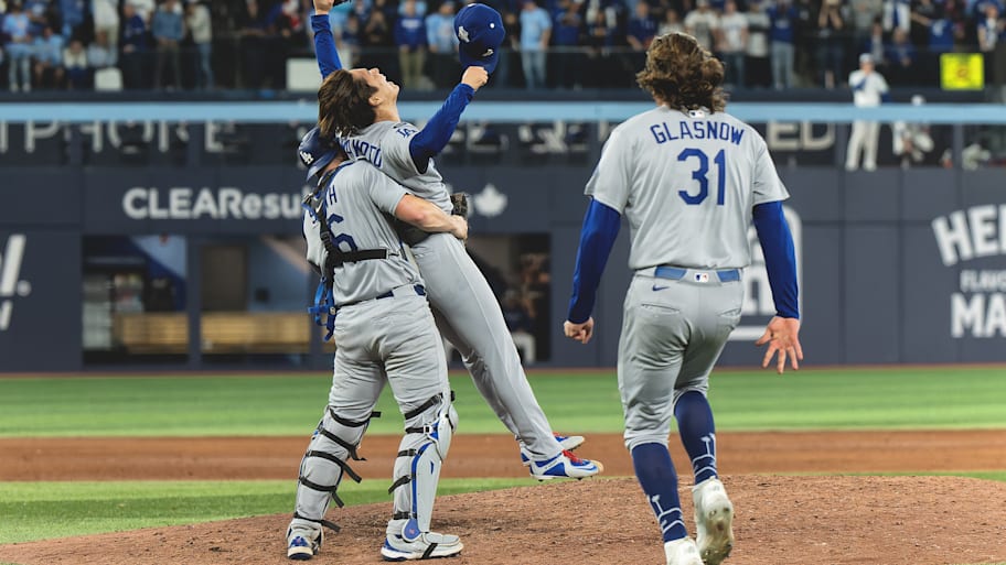 Dodgers catcher Will Smith and pitcher Yoshinobu Yamamoto embrace on the mound to celebrate 2025 World Series win