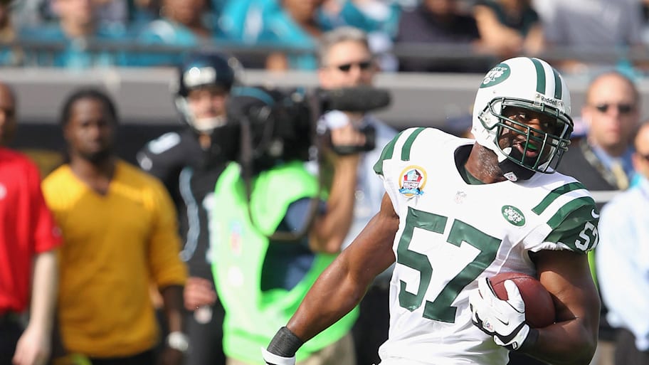 Bart Scott holding the ball after an interception.