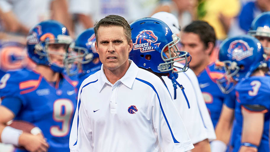 Chris Petersen standing on the Boise State sideline.