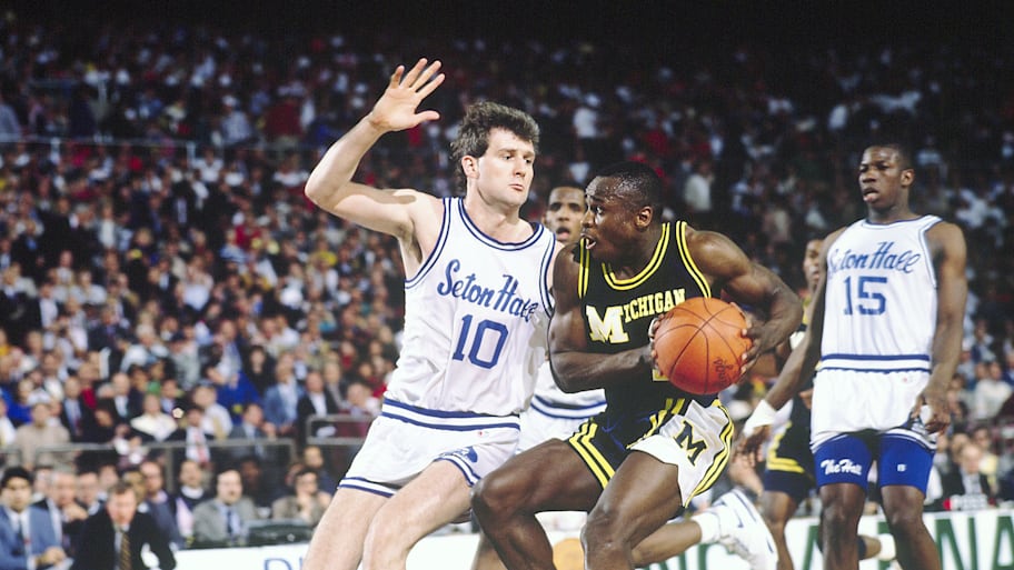 Michigan’s Rumeal Robinson dribbles against Seton Hall’s Andrew Gaze during the 1989 NCAA national championship game.