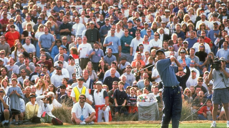 Tiger Woods watches the hole-bound shot at TPC Scottsdale's famed 16th hole in 1997.