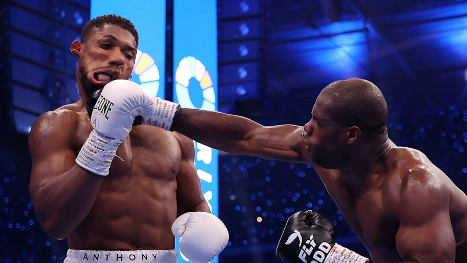 Daniel Dubois punches Anthony Joshua in the first round of their the IBF World Heavyweight Title fight