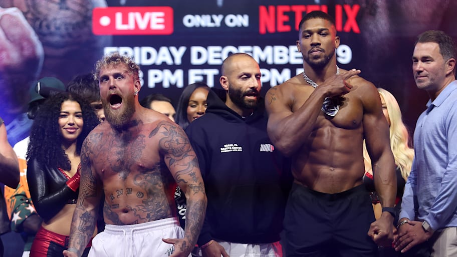 Jake Paul faces off against Anthony Joshua during the weigh-in at The Fillmore Miami Beach