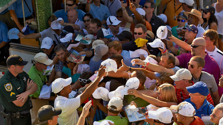 Tiger Woods signs autographs at Bay Hill in 2012.